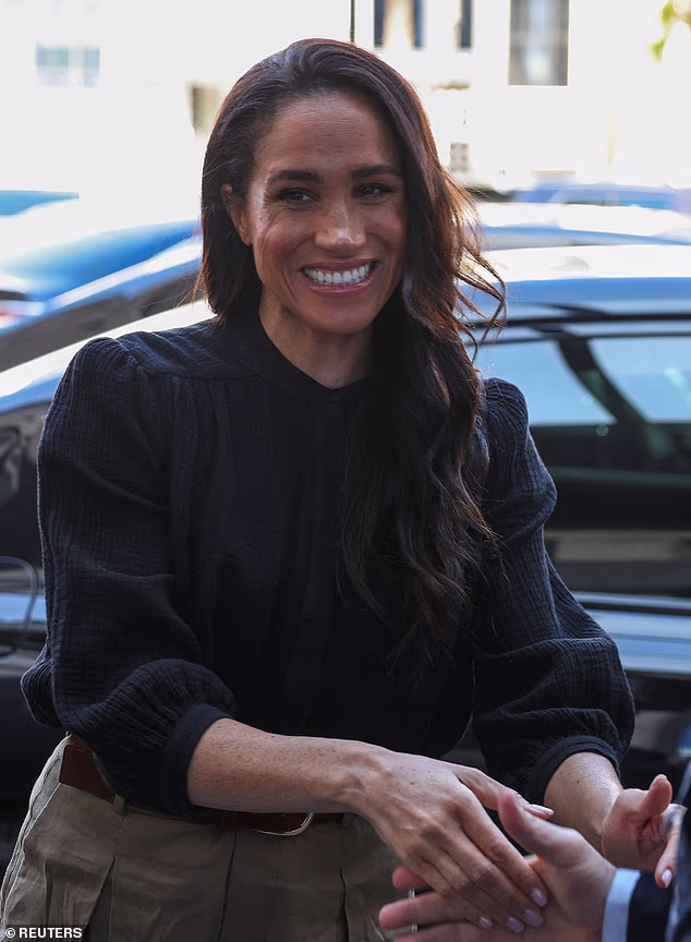 Further proving where her focus lay, the Duchess appeared to keep the creased trousers as part of her third outfit of the day, only changing her T-shirt for a smarter black blouse featuring statement shoulders