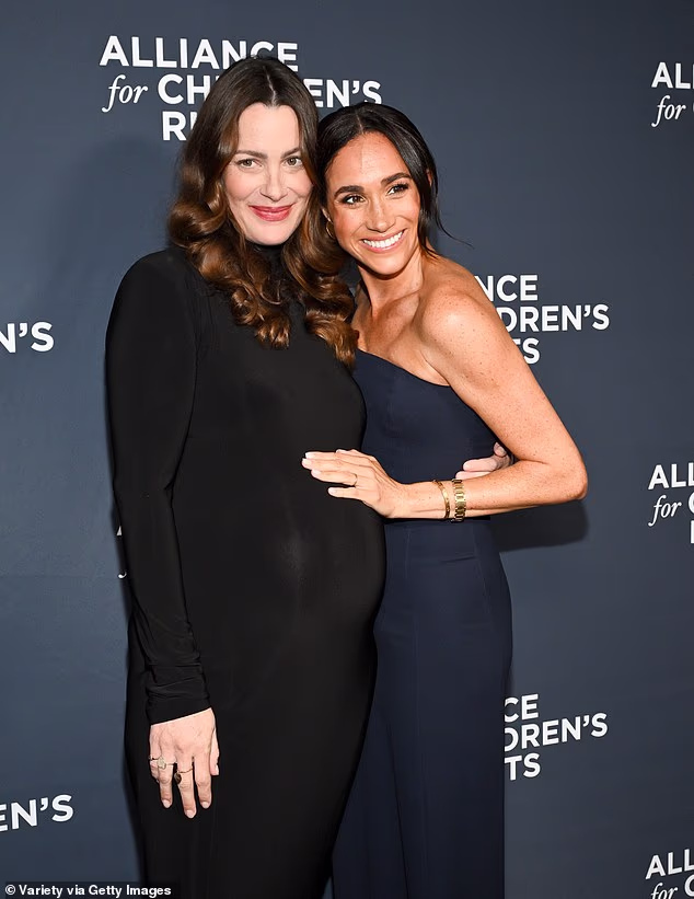 Meghan also rested her hand on Kelly's baby bump. She is expecting a child in the coming weeks
