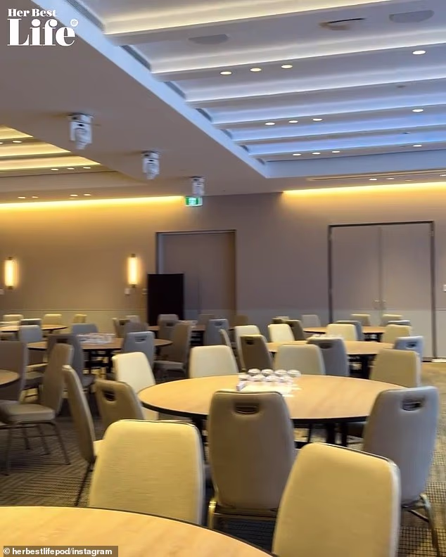 Several round tables were packed into a modest room, facing a small stage where two chairs sat next to a side table with water