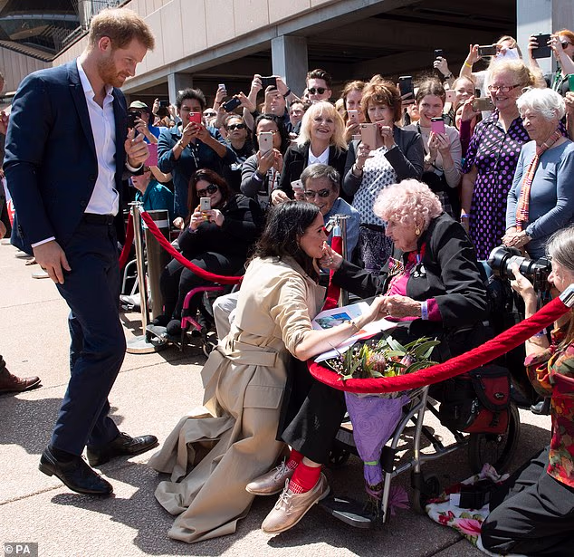 The Duke and Duchess of Sussex meet 98-year-old Daphne Dunne during a walkabout outside the Sydney Opera House on the first day of the Royal couple's visit to Australia in 2018