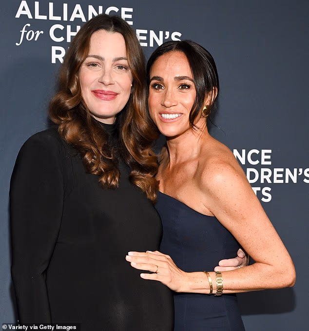 As the Duchess of Sussex beamed and hugged her best friend Kelly Zajfen at a charity bash in LA last night, missing from her finger were her dazzling diamond engagement ring and eternity band – as she instead opted for a simple, golden wedding ring