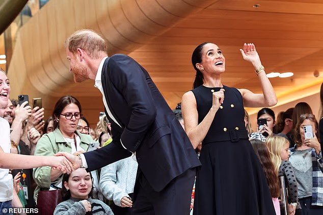 Meghan excitedly waved to people who were above them in the hospital atrium