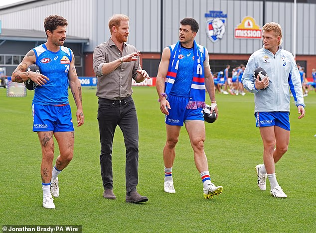 Sports-mad Harry (pictured with Liberatore, Matthew Kennedy and Treloar) chose to visit the club due to its ties to a charity that raises money for men's health