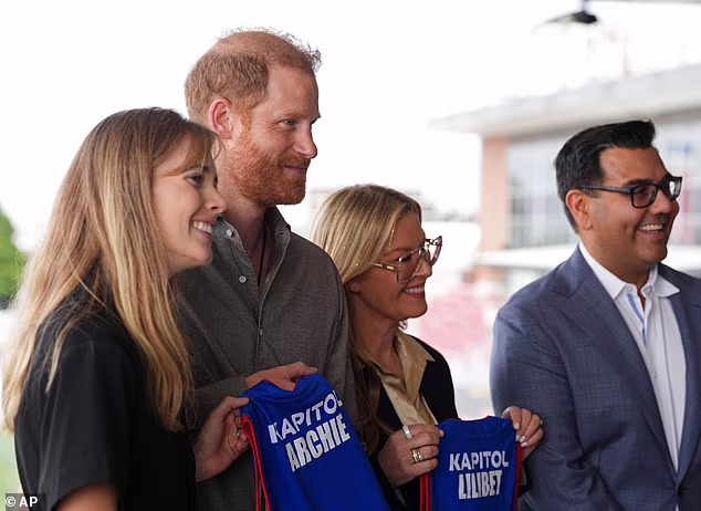 The Duke's two children were given every reason to become Bulldogs fans, with custom 'Archie' and 'Lilibet' jerseys presented to the Duke of Sussex (pictured)
