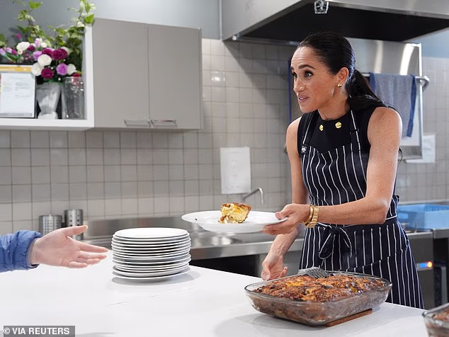 Later in the day, she went solo as she served frittata at a women's refuge wearing £1,100 heart earrings, Princess Diana 's Cartier watch and a Tiffany gold bracelet