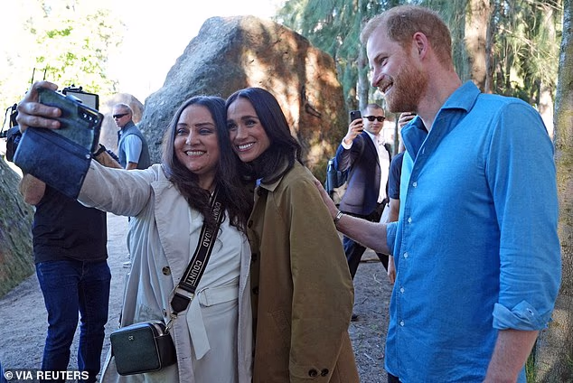 Harry and Meghan, the Duke and Duchess of Sussex, pose for a selfie photo at the Scar Tree Walk in Melbourne. They are more popular with young people in the UK than older generations