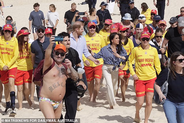 He swept in front of the couple and surf live savers during the couple's visit on Friday