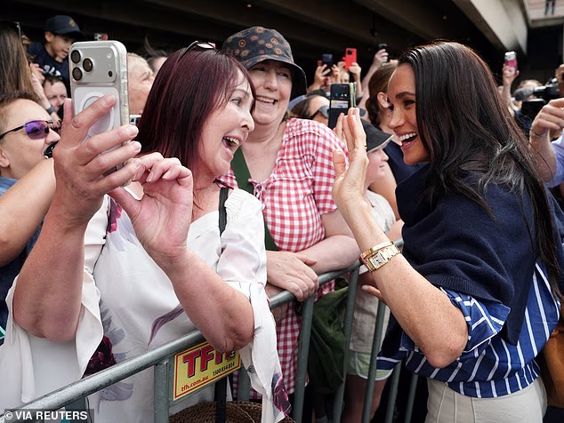 The Duchess of Sussex poses for a selfie photo with a fan