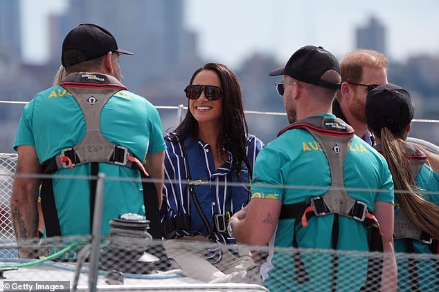 Meghan then looked very happy to be sailing around Sydney Harbour