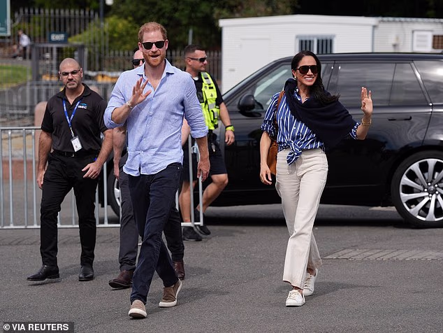 Harry, the Duke of Sussex arrives at the Man O'War Steps, next to the Sydney Opera House, with Meghan, the Duchess of Sussex