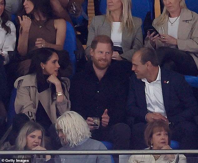 Prince Harry and Meghan talk to Australian Rugby CEO Phil Waugh as they attend the Waratahs Friday night Super Rugby clash at at Allianz Stadium