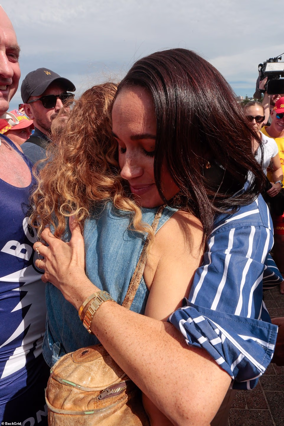 It has been replaced with a picture of the duchess waving as she left her luxury Range Rover 4x4 earlier in the day, in the same outfit but without Harry in shot. Meghan is expected to earn a portion of OneOff's sales commission, which ranges from 10 per cent to 25 per cent per item sold. She is also an investor in the AI-powered fashion business. It came as a Bondi beachgoer was praised after footage of the Sussexes on the sand captured her refusing to move when her sunbathing session was interrupted by Harry and Meghan. And an exclusive poll for The Mail on Sunday revealed how an overwhelming four-to-one majority of Britons are opposed to the Sussexes using their titles for commercial gain. The Duchess of Sussex had looked deeply moved as she listened to stories from those who witnessed the horrific antisemitic massacre in December that claimed 15 lives. Meghan also embraced Jessica Chapnik Kahn, who survived while shielding her five-year-old daughter after attending a Hanukkah party. She and Harry also spoke to first responders to the Bondi terrorist attack, including lifeguards on the beach.