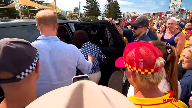 Harry then held the door for the duchess as they climbed into their Range Rover