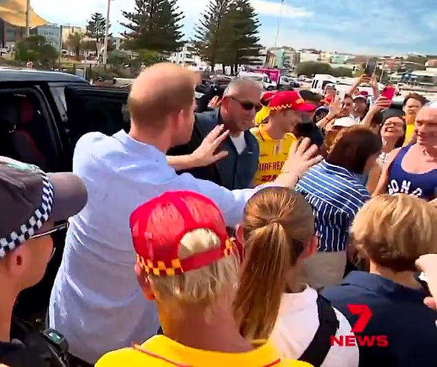 The funny moment Harry yells 'easy, easy' as Meghan hugs a fan in Australia last week