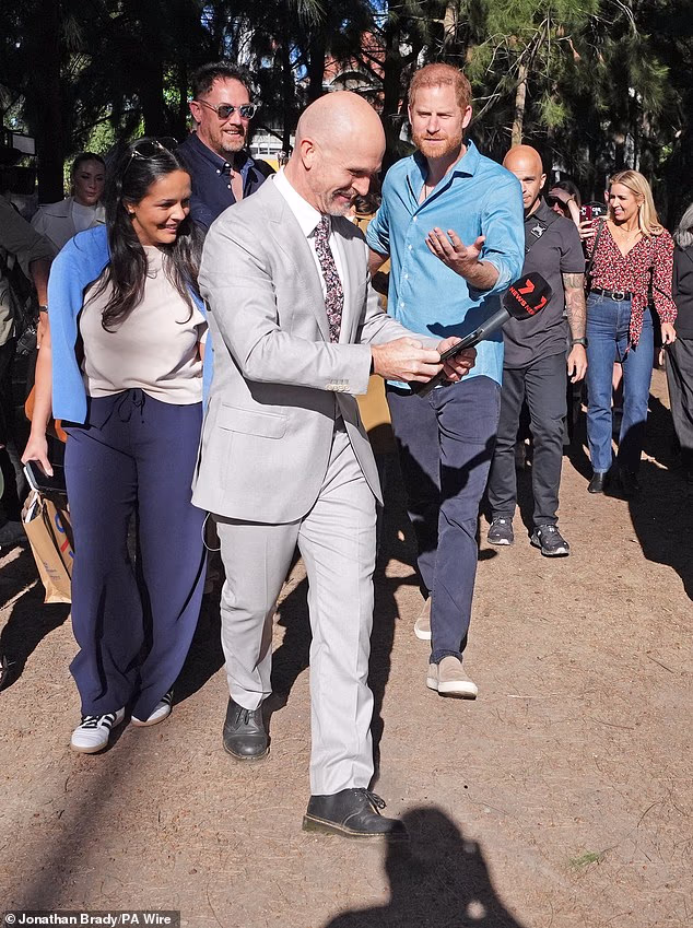 Harry looked annoyed when a reporter asked for a selfie as they left Scar Tree Walk in Melbourne, getting in Meghan's way