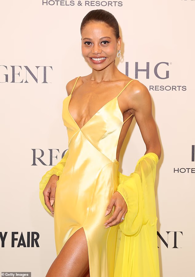 With a strappy, plunging neckline, Emma's elegant gown ensured she commanded the lion's share of attention while posing for pictures at Carlton Beach Club