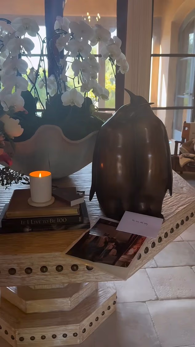 Meghan Markle has shared a sweet video of Prince Harry delivering her a cake and a penguin statue present as the pair celebrate their eighth wedding anniversary