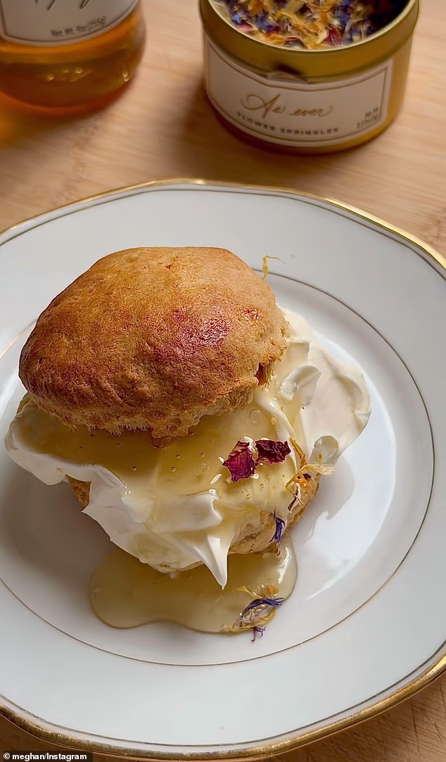 On Meghan's lifestyle brand As Ever's Instagram account, a clip (pictured) was shared over the weekend illustrating a sliced scone before a dollop of cream was added first. The sweet treat was finished with a spoonful of Meghan's raspberry spread, honey and flower sprinkles