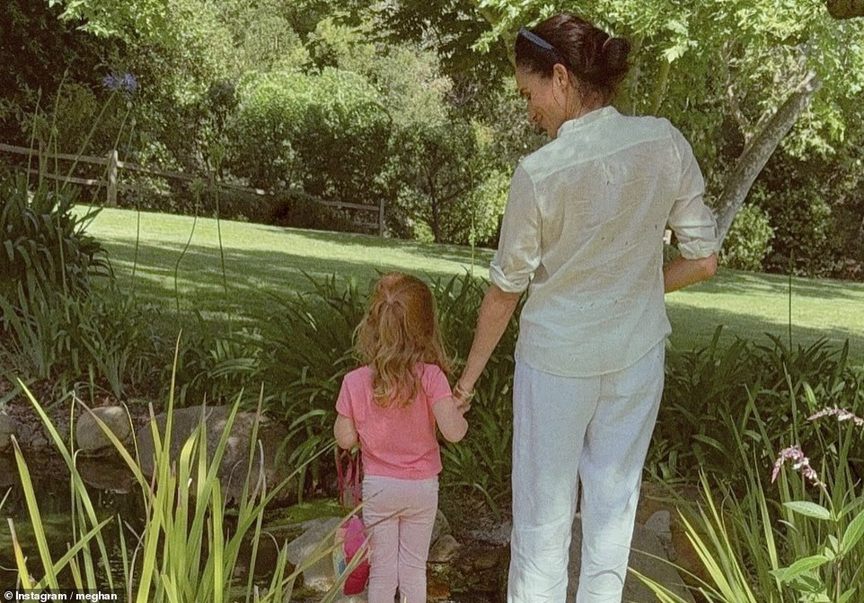 Harry, 41, is shown with his hands cupped protectively around Archie's head. The father and son are staring at one another lovingly, both with smiles on their faces. Next to them on a bridge are Meghan and Lilibet. The Duchess is bent down to rest her forehead against her daughter's while holding both her hands. In dappled California sunshine, Lilibet's face is covered by her hair, which comes down to her shoulder blades. While Lilibet's face was hidden in earlier photos, fans finally saw what she looked like in Meghan's Valentine's Day post. The Instagram snap showed Harry smiling as he held the princess in his arms while Lilibet clutched a bunch of red balloons. It sent fans into overdrive with people commenting on her red hair 'like her father' and her being 'beautiful just like her daddy'. Meanwhile, Archie's face has not been seen in a photo since the Sussexes' Christmas card in 2021. The Duke and Duchess of Sussex have both advocated for stronger protections for children online, including backing a social media ban for under-16s brought in in Australia.