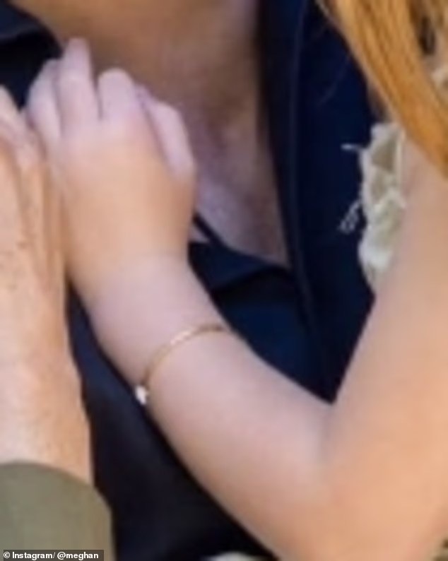The five-year-old's gold bracelet bares a resemblance to Meghan's trademark Cartier Love bangle