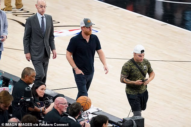 Harry was seen walking off the court with Silver as the San Antonio Spurs played the New York Knicks