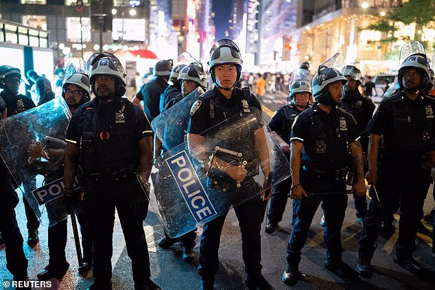 Police officers armed in riot gear prepare to disperse the crowd at Bryant Park
