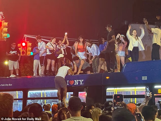 In photos captured by Daily Mail, fans in Brooklyn were seen climbing on top of the city's local buses as the celebrations ran riot throughout all five boroughs of the city