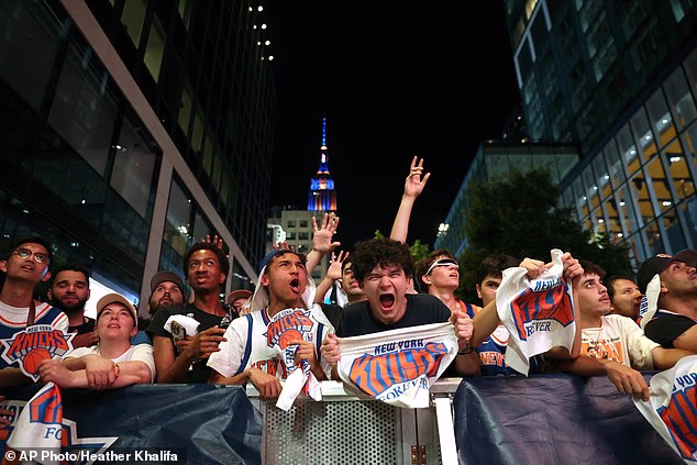 Knicks fans are pictured wildly celebrating the victory at the Game 5 watch party
