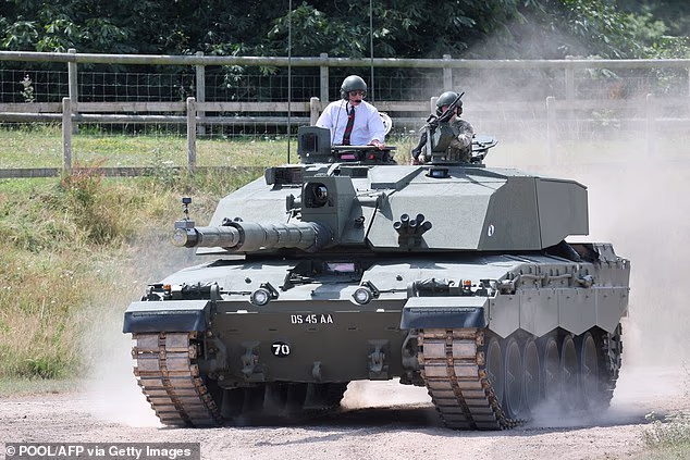 Donning goggles, a white shirt, and a striped tie, Charles, 77, sat in the commander's seat as he was shown around the Tank Museum at the Royal Tank Regiment (RTR) this afternoon.
