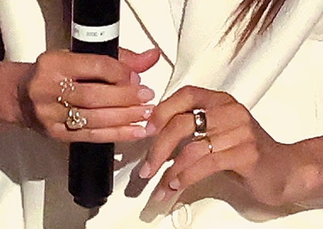 The Oura ring and gold case on her left hand is a new addition as is the mystery band on her right hand, worn under a massive five-carat sparkler