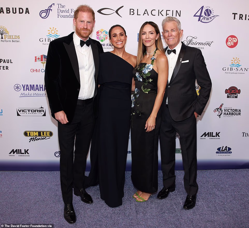 The apparent snub was an accident, the source claimed, noting that he was likely distracted by his hosting duties. They added: 'As host of the evening, David had a lot going on. David was doing interviews in that moment too.' The insider continued: 'They had already said hi before that photo moment. There were lots of hugs and David introduced Harry and Meghan to his other family there.' Body language expert Judi James has also analysed the moment, telling the Mail that Meghan was in 'pose alert' as Foster and McPhee arrived on the red carpet.