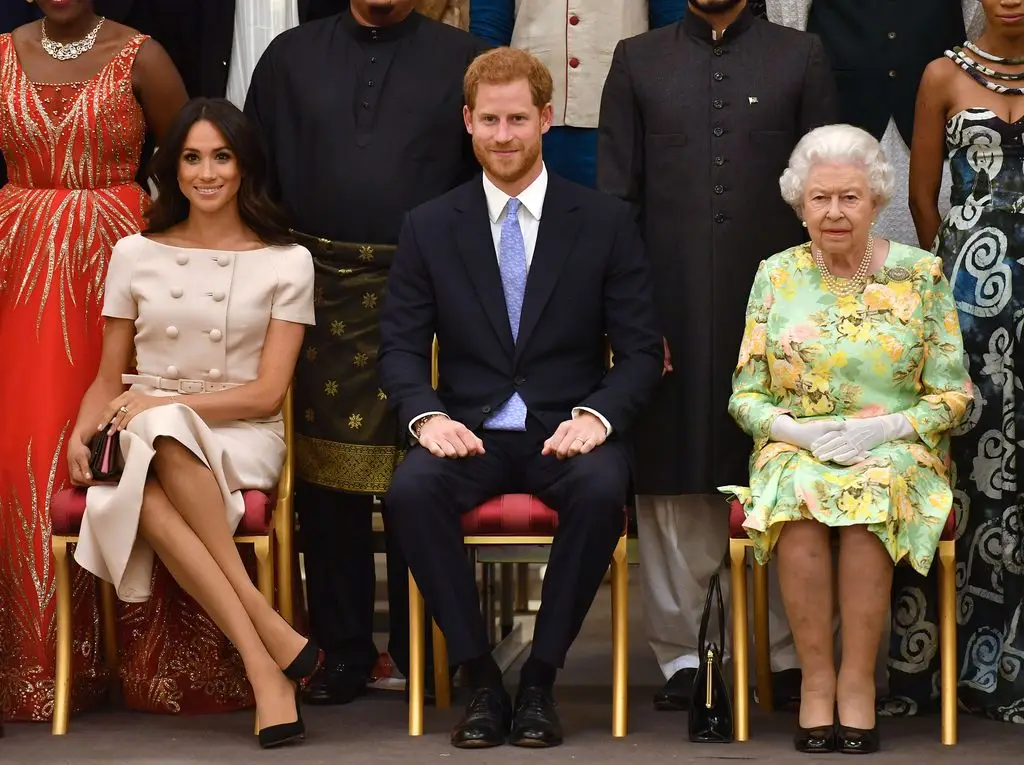 Meghan, Duchess of Sussex, Prince Harry, Duke of Sussex and Queen Elizabeth II at the Queen's Young Leaders Awards Ceremony at Buckingham Palace on June 26, 2018 