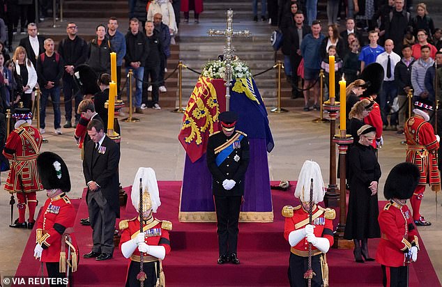 William and Harry stood either end of the Queen's coffin as her grandchildren held vigil last night, while mourners continued to file past