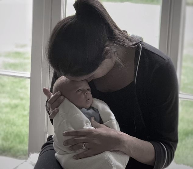 In another emotional shot, Meghan cradles Archie as a tiny baby as she sits on a window sill, pressing her forehead against her son's