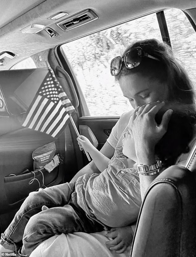 The three-year-old is pictured throughout the first three episodes of the Netflix series- including this undated black-and-white shot of him holding an American flag