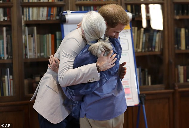 The naturalist, who¿s regarded as the world¿s foremost expert on chimpanzees, may be reluctant to say more about her royal friends after the furore caused by the Vogue chat (pictured hugging Prince Harry in 2019)