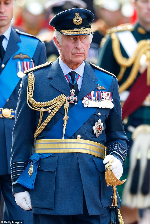 King Charles III walks behind Queen Elizabeth II's coffin as it is transported on a gun carriage from Buckingham Palace to The Palace of Westminster on Wednesday