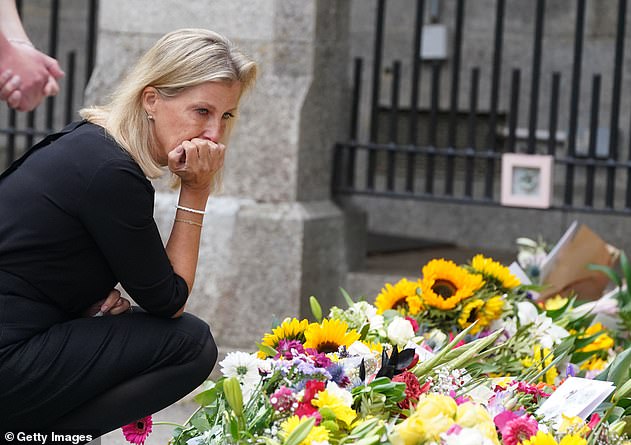 The teary-eyed Countess of Wessex, Sophie studies the floral tributes and loving messages left to her mother-in-law, the Queen, at Crathie Kirk church near Balmoral on Saturday