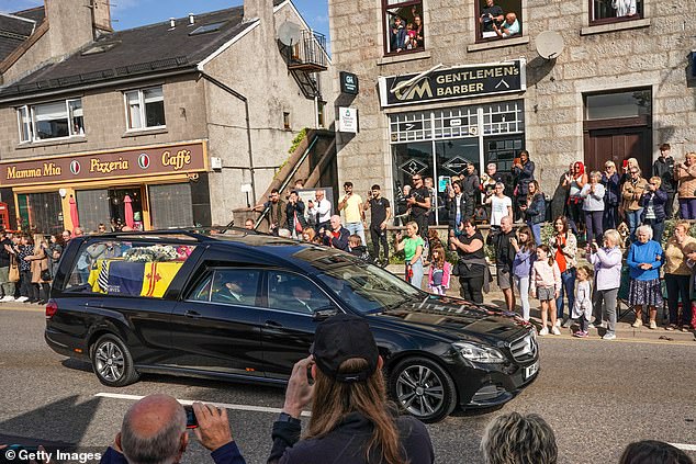 King Charles III formally approved an order declaring Monday, September 19 as a holiday at St James's Palace in London on Saturday. The Queen's funeral will take place at Westminster Abbey at 11am. Mourners are pictured in Banchory, Scotland as the hearse carrying Queen Elizabeth travels through the area