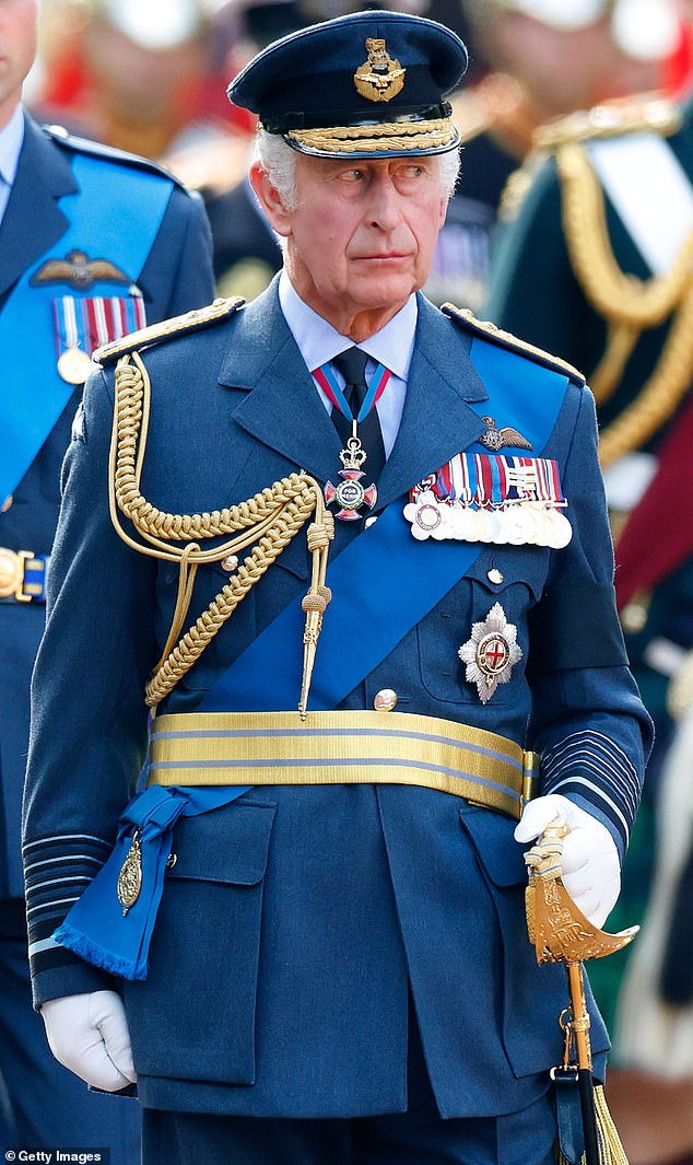 King Charles (pictured walking behind his mother, the Queen's coffin as it is transported from Buckingham Palace to Westminster Hall on September 14) is said to be undecided on whether to let his youngest grandchildren Archie and Lilibet use the prince and princess titles