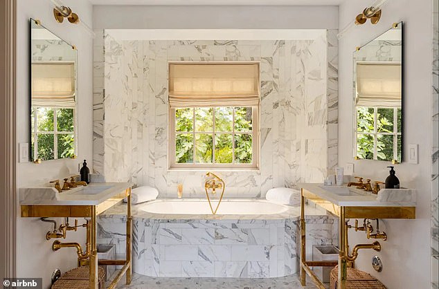 Beautiful: The guesthouse bathroom had a gold, white and gray color scheme