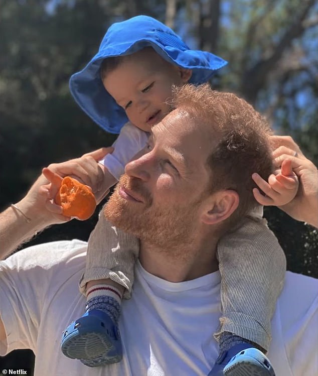 Princess Lilibet, two, and four-year-old Prince Archie's (pictured with Prince Harry) upbringing is 'very play-based', the insider claimed to the US magazine , adding: 'They have several play areas, including a climbing gym on their property.'