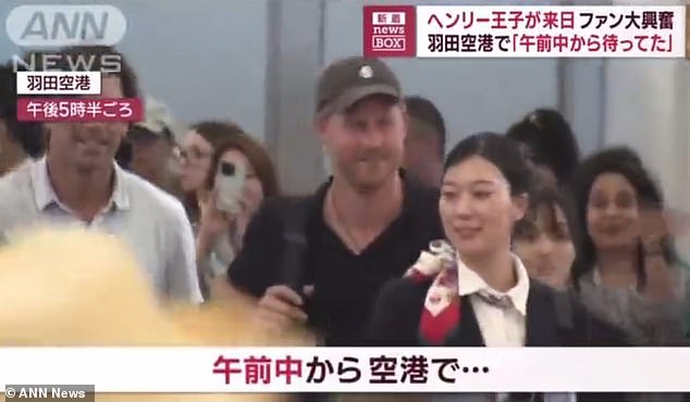 Harry arrives at Haneda Airport yesterday with his friend, polo player Nacho Figueras (left)