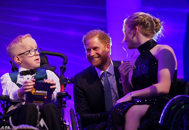 The Duke of Sussex speaks with Blake McCaughey (left) and Hayley Cassin on stage, during the annual WellChild Awards 2023, at the Hurlingham Club in London