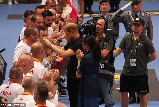 Meghan and Harry hand out gold medals to Poland following their victory in the volleyball final