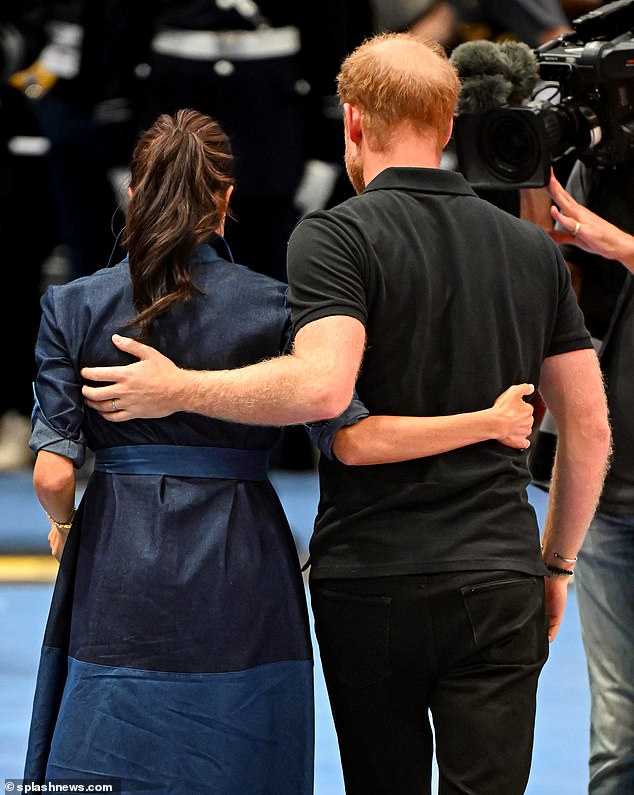 The Duke and Duchess embrace following the medal ceremony