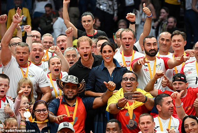 Prince Harry, Duke of Sussex and Meghan, Duchess of Sussex pose for a group photo with the competitors