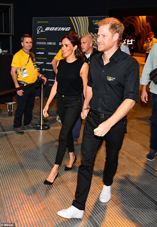 Meghan and Harry arrive hand-in-hand at the Merkur Spiel-Arena in Dusseldorf