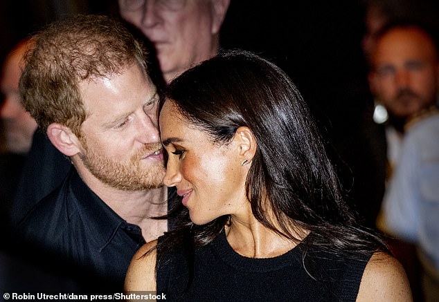 The Duke and Duchess of Sussex held hands, cosied up to one another and were seen affectionately leaning towards each other as they attended the wheelchair basketball finale at the Merkur Spiel-Arena in Dusseldorf, Germany