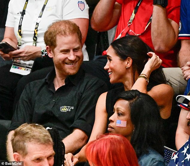 The Sussexes smile at eachother and both were in high spirits on Wednesday